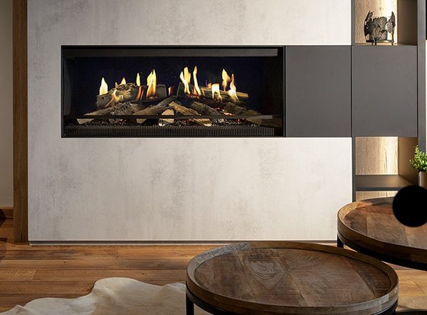 An image of a wall in a sitting room with a panel pulled aside to reveal a fireplace in the wall.