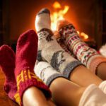 A family enjoying a fireplace with fuzzy socks on