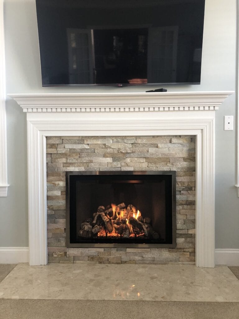 new stone fireplace with white mantle