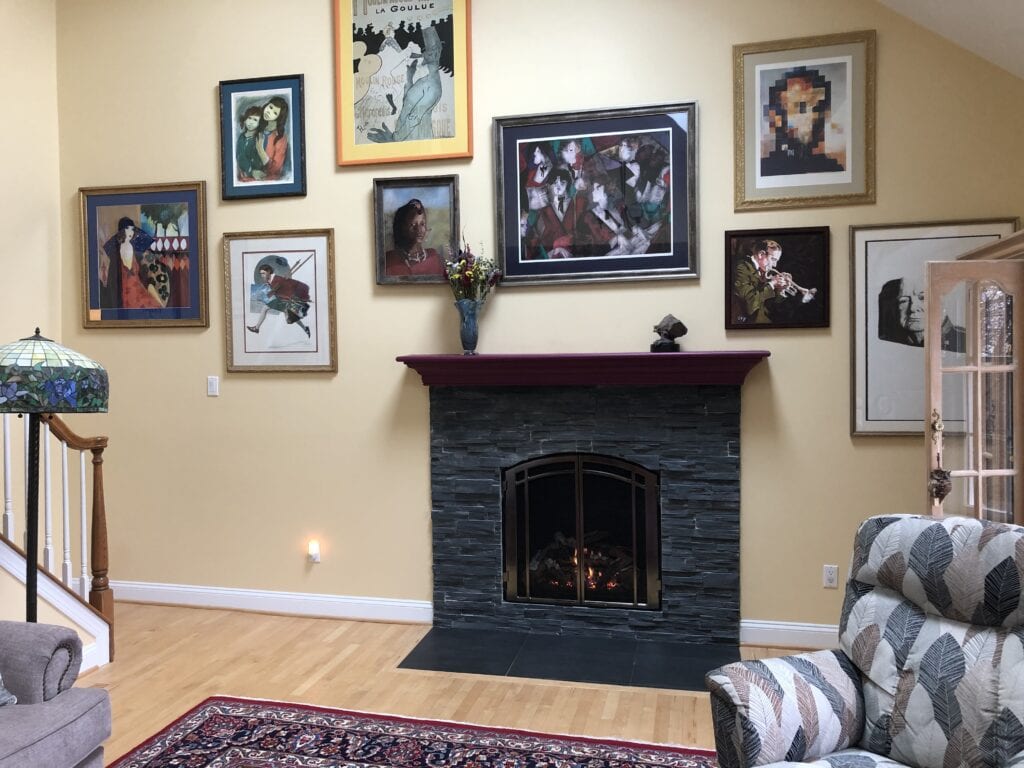 fireplace surrounded by framed art