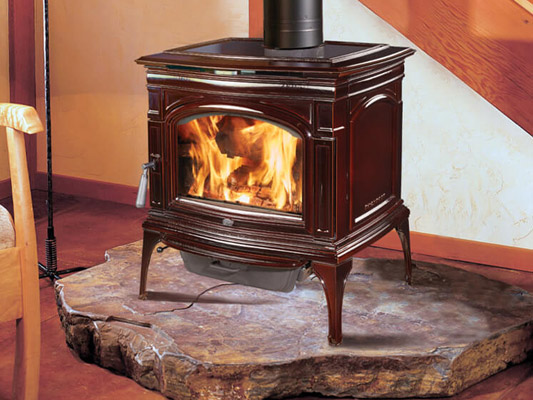 brown ceramic wood stove on live edge wooden mantle
