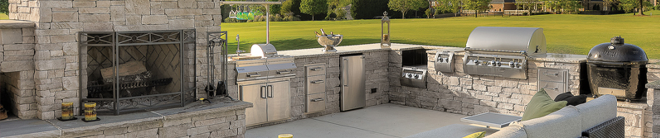 built in kitchen outdoors with stone countertops
