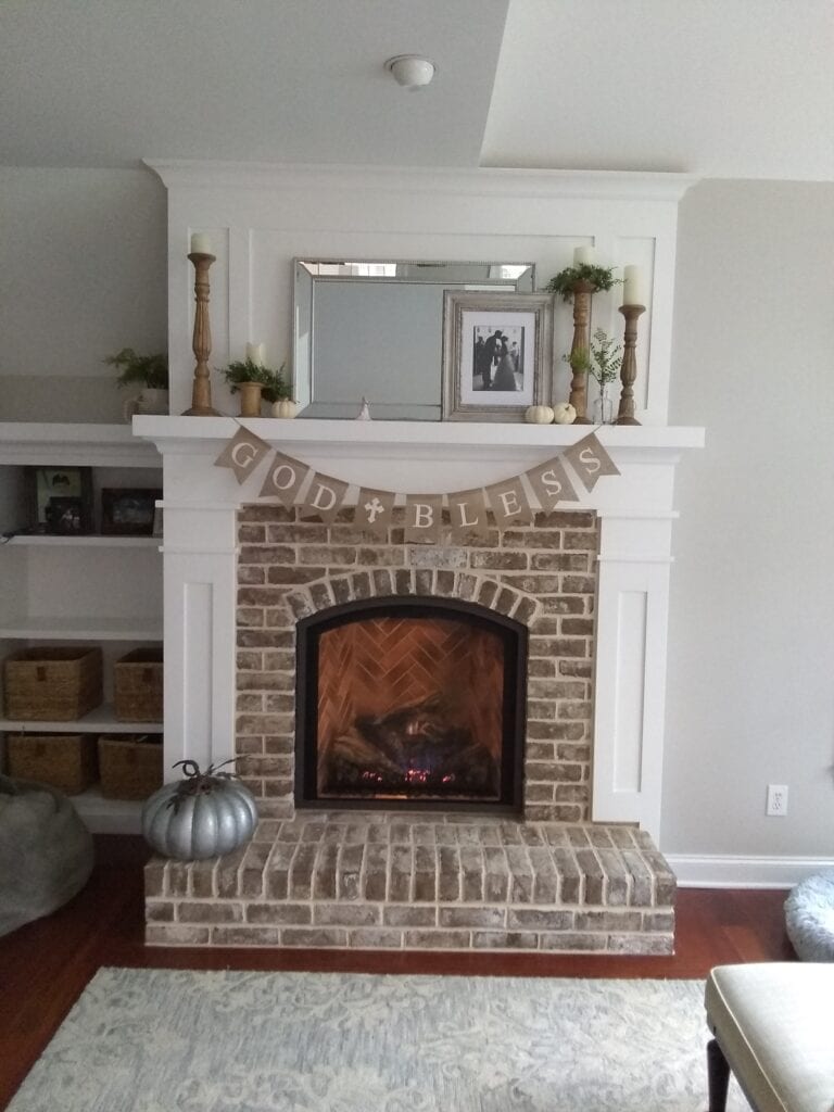 brick fireplace with white trim