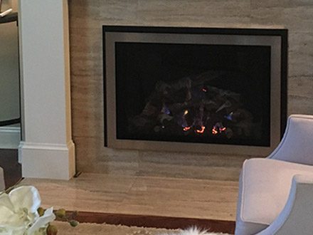 an image of a sleek gas fireplace insert in a living room with a grey and beige color scheme.