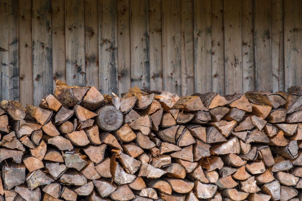 A stack of logs to be used as fuel for a fireplace.