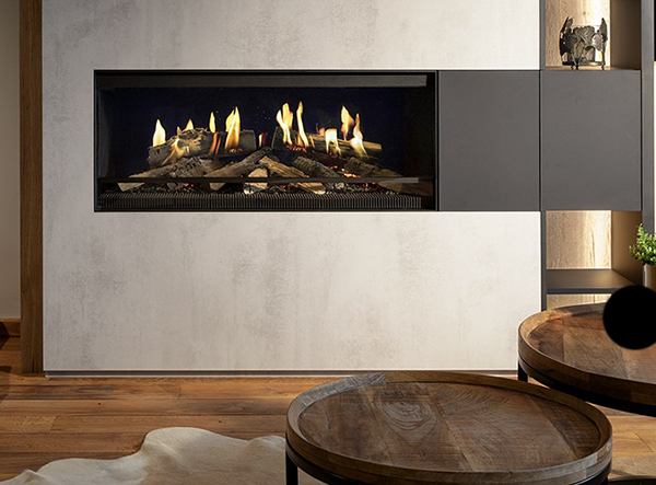 An image of a wall in a sitting room with a panel pulled aside to reveal a fireplace in the wall. 