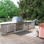 An outdoor kitchen island with a built-in grill.