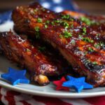 close-up of a plate of barbecue ribs with red and blue garnish