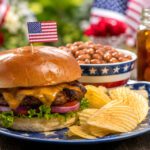 Burger with American flag at an outdoor summer picnic.